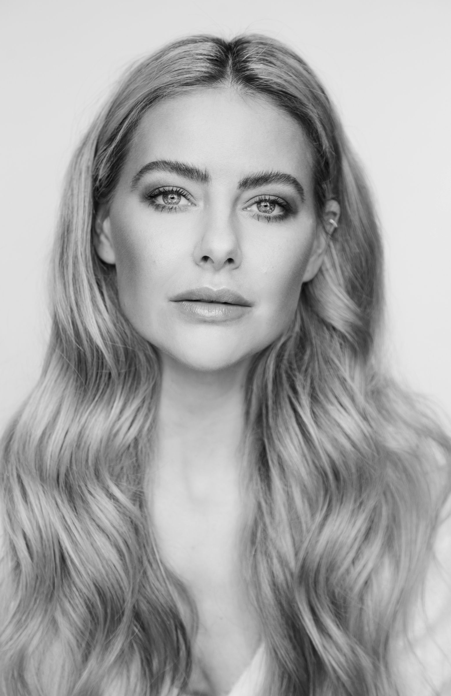 Black and white portrait of a woman with long wavy hair.